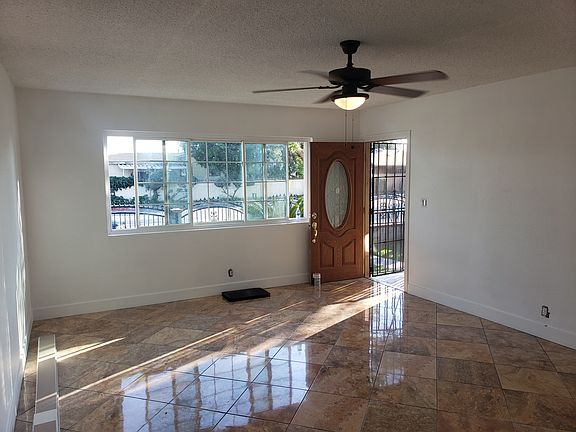 Enter to spacious living room, tile floor throughout, new ceiling fan.