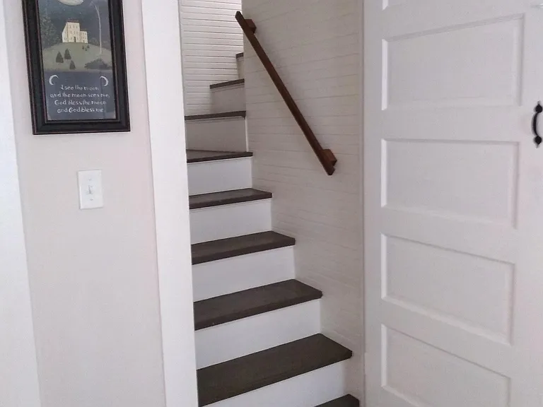 Enclosed staircase leading to second level.
