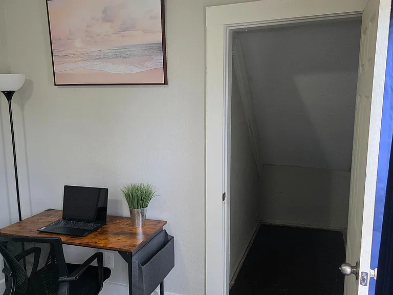 Multipurpose room with a dedicated desk nook and convenient adjacent storage/closet area for everyday organization.
