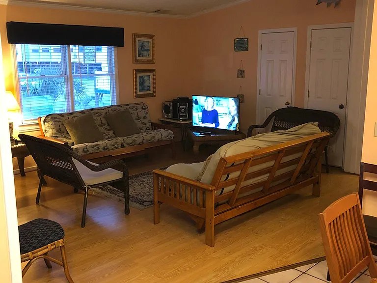 Den with view of pool and ocean