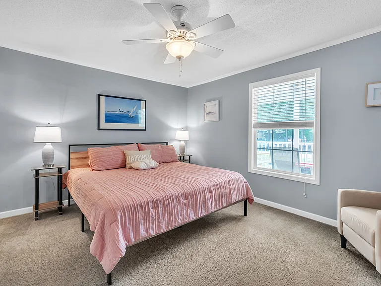 Master Bedroom with king-size bed and a bathroom on the left. Also has a ROKU tv and a dresser (not shown)