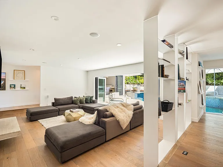 From the living area's sofa, catch your favorite shows on TV with direct access to the pool just steps away.