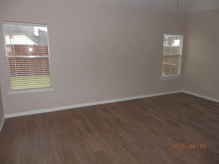 Large primary bedroom overlooking private backyard. No neighbors behind home. Vinyl plank flooring.