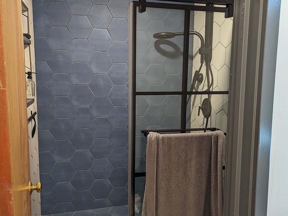 Custom shower with Nebia by Moen fixtures, including handheld wand.