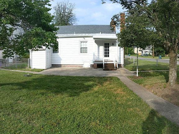 Fenced in back yard, attached shed, concrete patio, metal roof on rear.