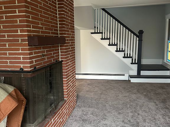 Living Room with stairs to upstairs 2 bedrooms and Bath