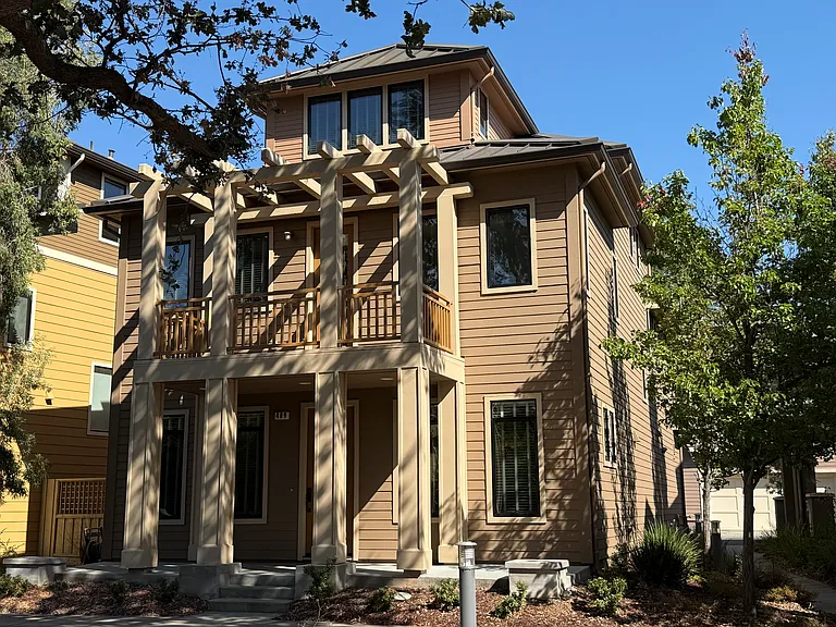 Landscaped front yard and covered porch welcomes you to this charming home situated in a prime location overlooking the community green belt.