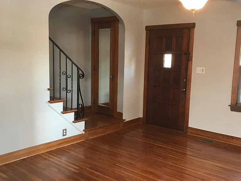 Ceiling fan in Living room and original (1930) hardwood floors and iron railing