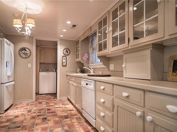 Note the double oven, warm brick floor, beautiful display cabinet and  bright kitchen window ready for you to entertain.