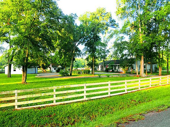 Standing on the far east of the property, looking down the fence line in front of the home.