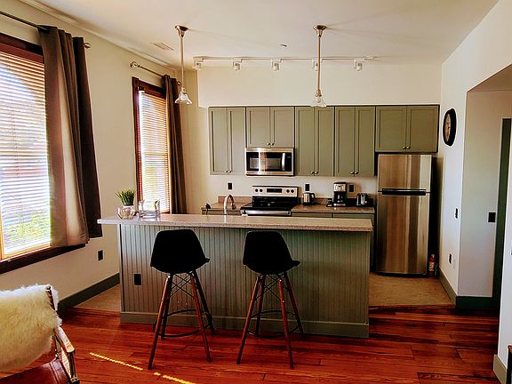 View from living room couch into the rest of the living room/kitchen. Make your coffee and work on your laptop using the high-speed Internet from your couch or the kitchen island