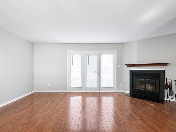 Living room with wood flooring and fireplace
