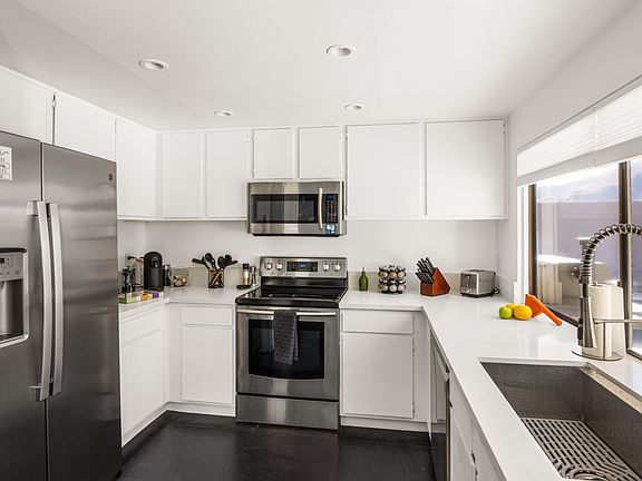 Fully stocked kitchen with Nespresso, electric kettle, and more