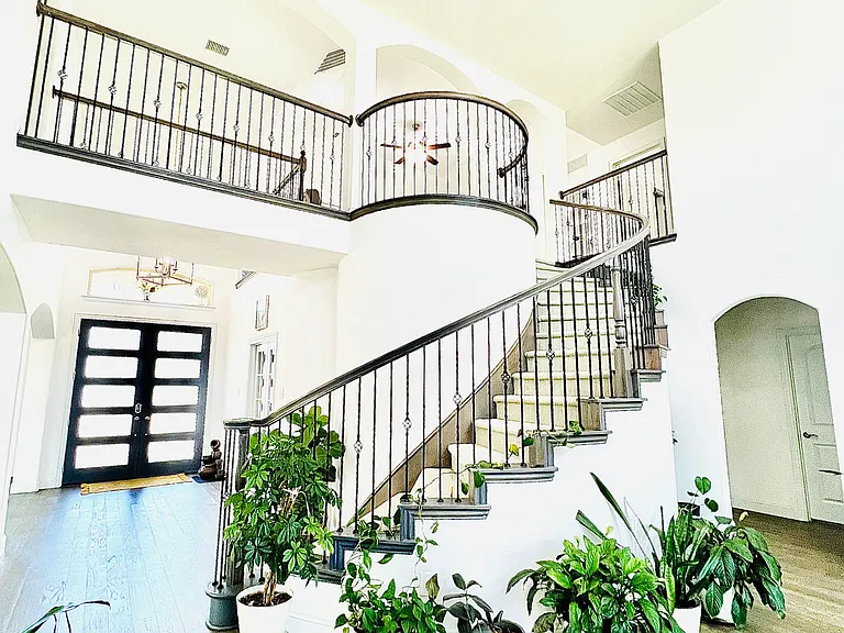 Graceful curved staircase leading from the living area