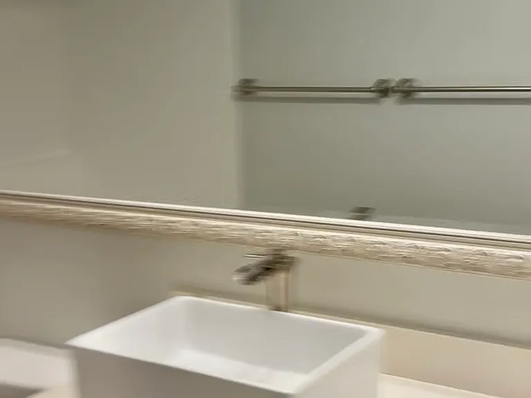 New water fountain faucet sink and extra large mirror. Washer and dryer are in a closet attached to the bathroom.