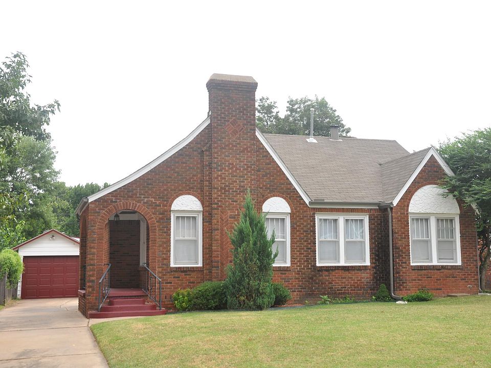 Front view of home and garage. The flower beds are begging for a green thumb.