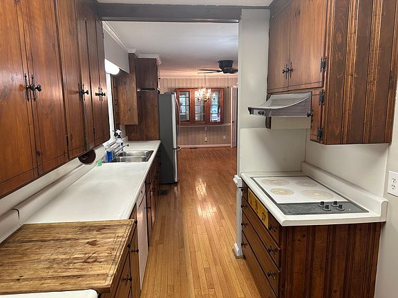 Kitchen view from the laundry room. Dishwasher is under the cutting board