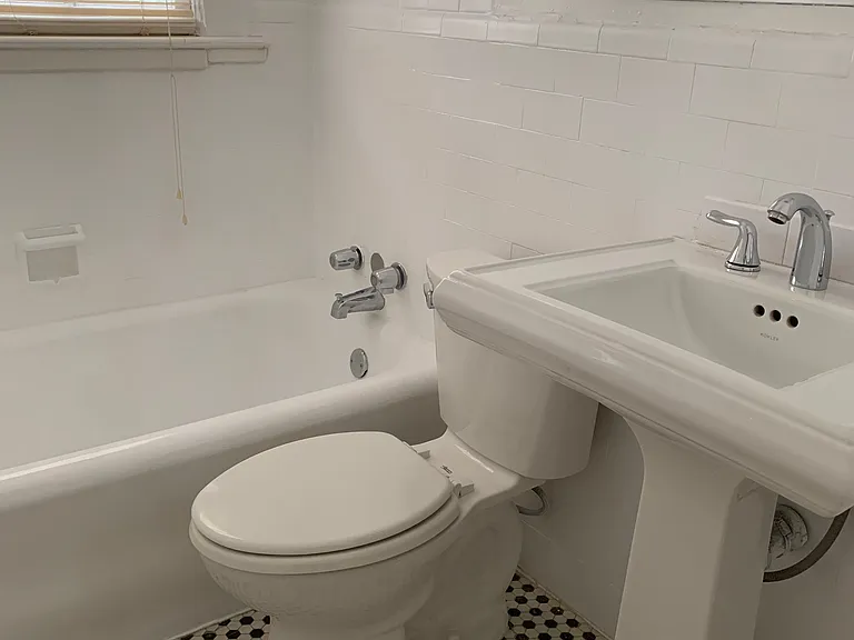 Tiled bath with tub/shower combo and natural light