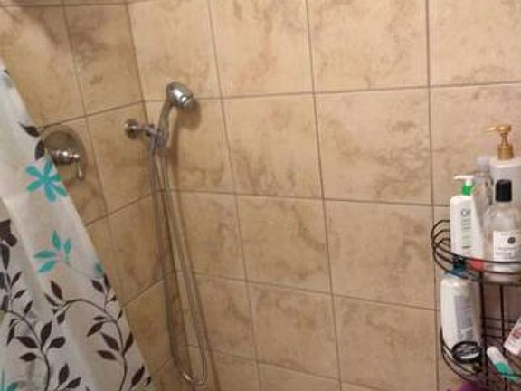 Tile shower with removable shower head.