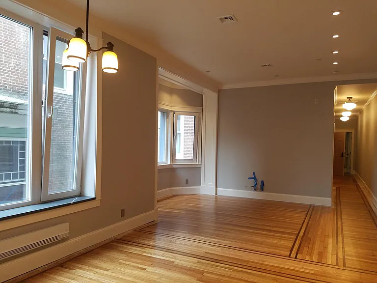 Huge living-dining room, wired for TV/data. stone sills and recessed lighting and dining chandelier.