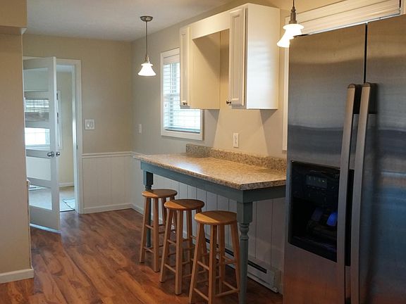 Eat-in bar in the kitchen opens into the sun room / dining room area.