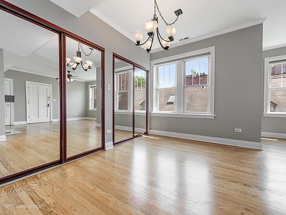 Mirrored closet doors and dining room hanging light fixture
