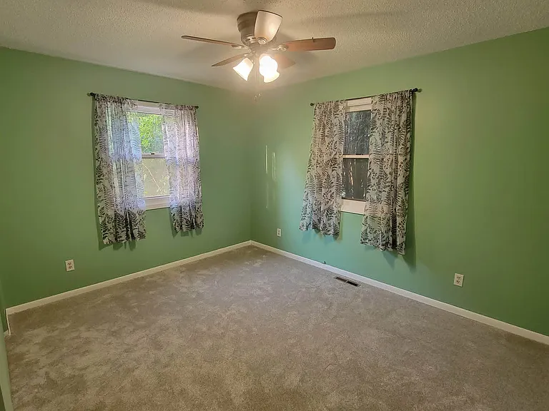 Second bedroom. Two windows, huge closet, new paint, carpet, ceiling fan.