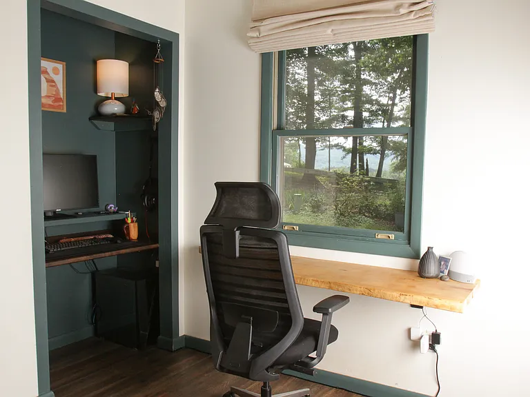 Second bedroom built in home office space includes floating desk with window view and cove focus desk