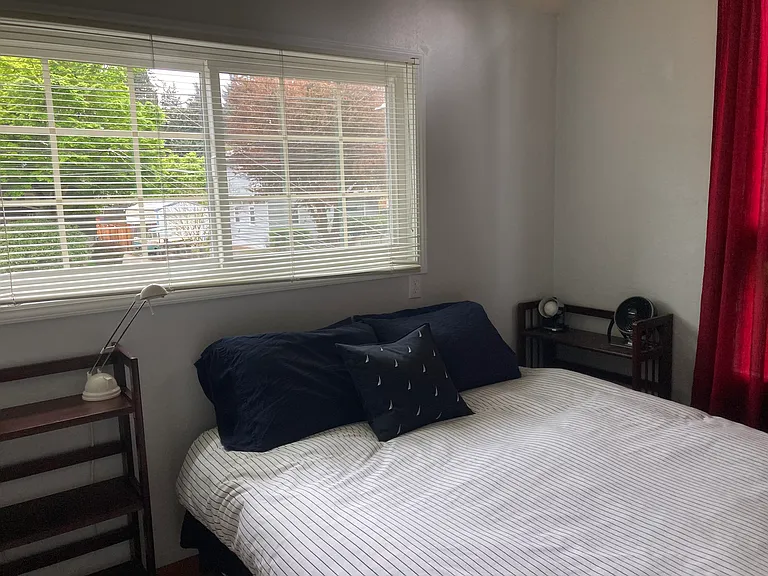 Main bedroom with view of the private front yard with lush greenery