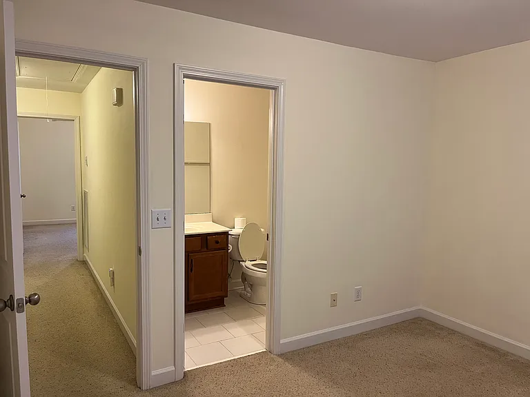 View from inside guest bedroom toward main bedroom at the end of the hall