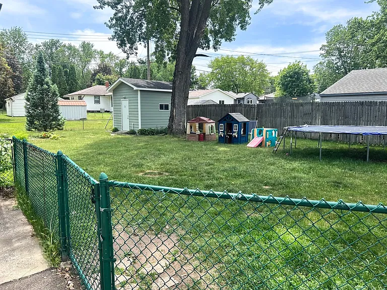 Fully fenced backyard with shed