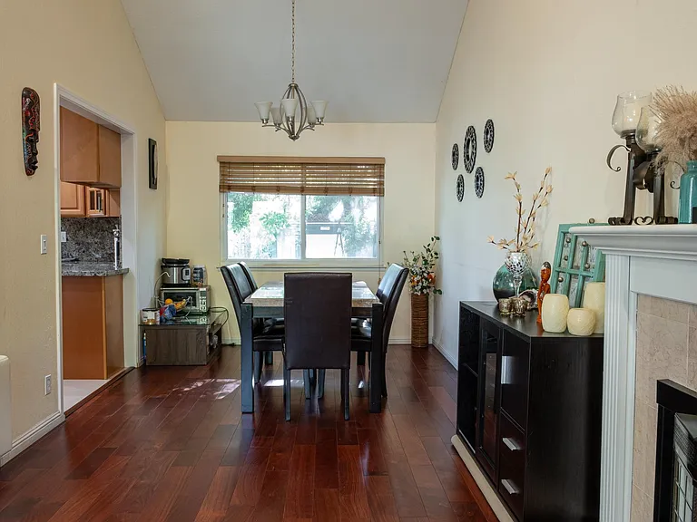 Dining room as an L shaped extension of living room, all hard wood flooring