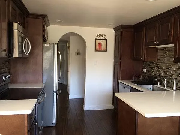 Fully redesigned kitchen featuring custom cabinetry, gorgeous countertops, and brand-new, top-of-the-line stainless steel appliances.