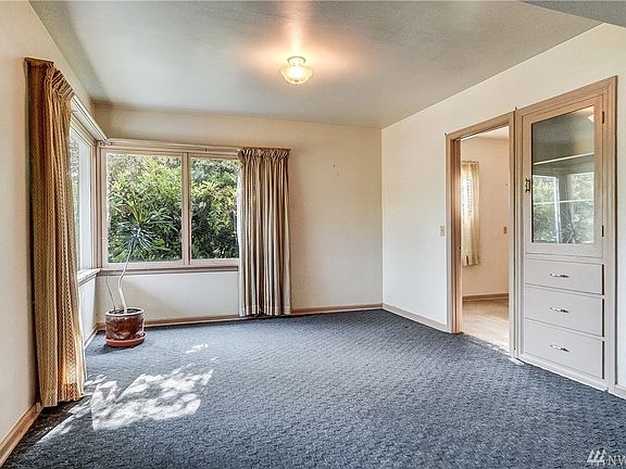 This charming living room has built-in shelves and cozy fireplace. 