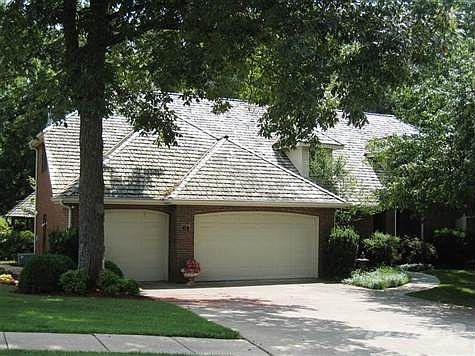 Home showing the lovely mature trees- new composition shingle roof on now.