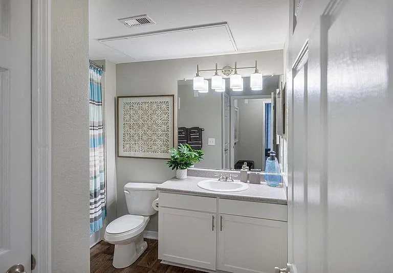 Bathroom with a tub and shower, toilet, and vanity