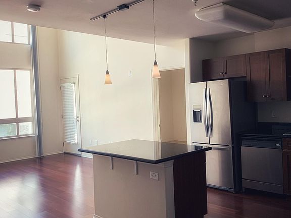 Living room and kitchen. Granite counter tops, kitchen island.