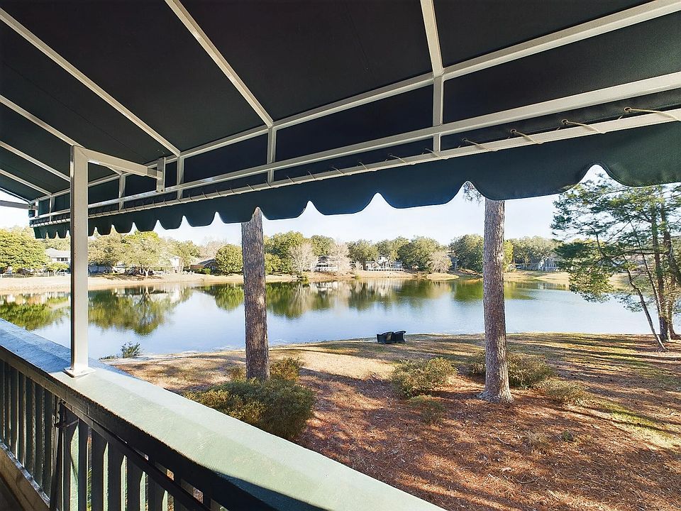 Rear covered balcony off living area overlooking the lake.