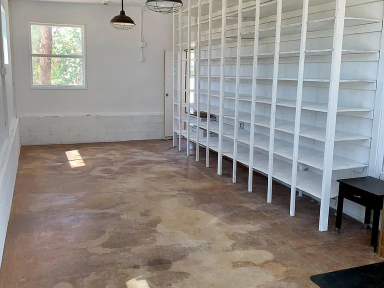 Downstairs studio looking towards entrance and shelves