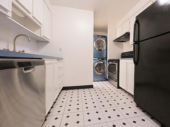 KItchen with full sized washer & dryer. The half bath is to the left of the washer & dryer
