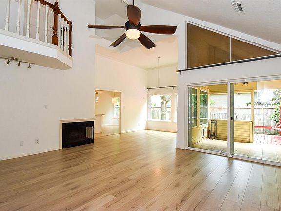 Great open floor plan featuring high ceiling, recent ceiling fan, corner fireplace and lots of natural light.