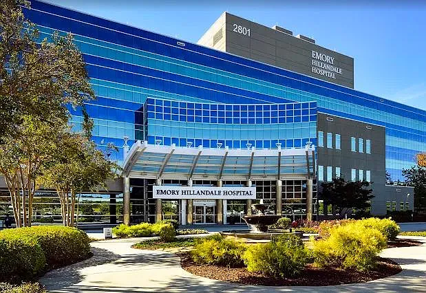 Landscaped exterior entry with covered drop-off, wide walkways, and a prominent main entrance for easy access.