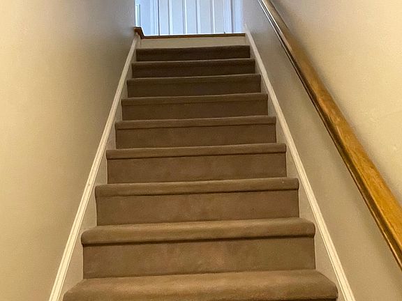 Entry and stairway to coat closet