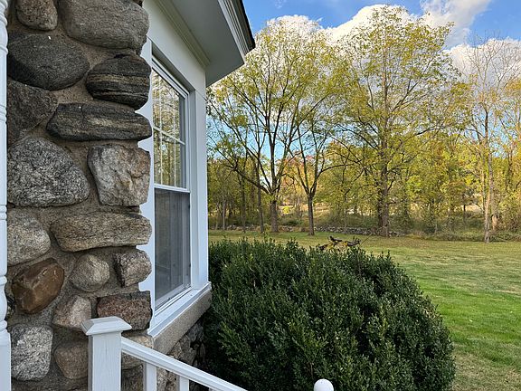 Front porch overlooking expansive side yard