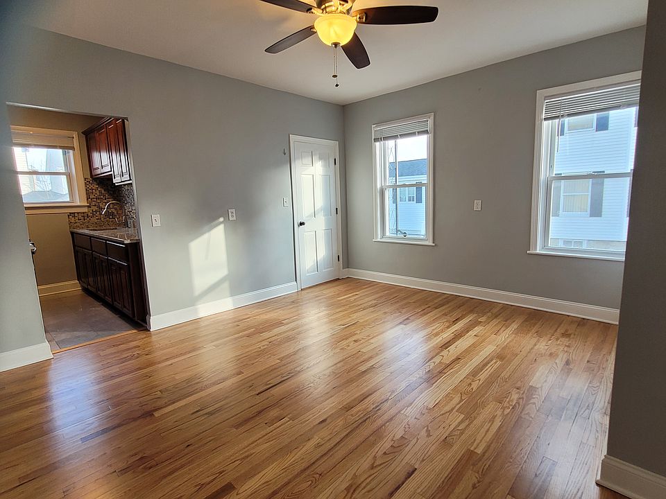 Dining area, galley kitchen on left, apartment entry door in middle.