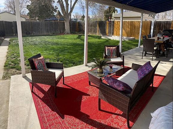 Backyard ; covered patio and fully fenced backyard. Enough space on the patio for a table for (8), and a separate seating area.