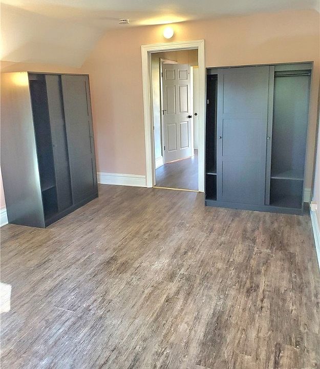 Large bedroom with two wardrobes for clothes.