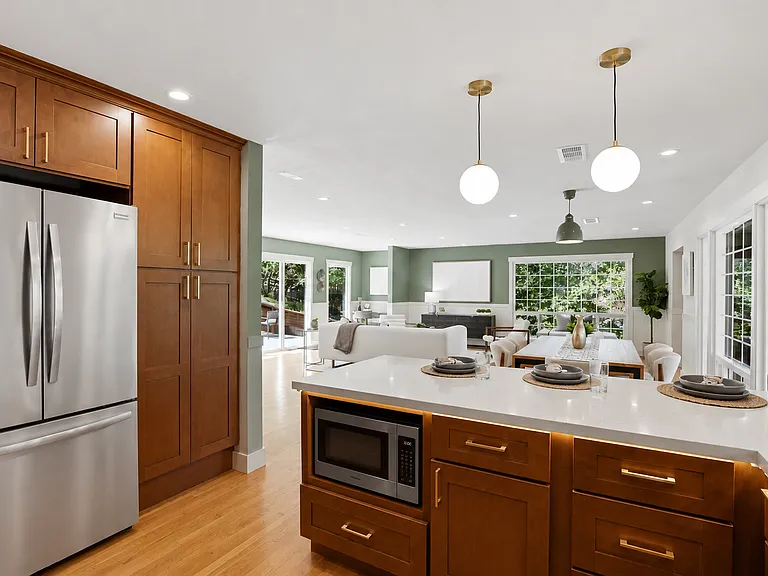Renovated kitchen with custom cabinetry and quartz surfaces