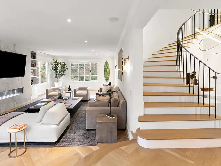 Grand staircase sits next to this large state of the art entertainment space.