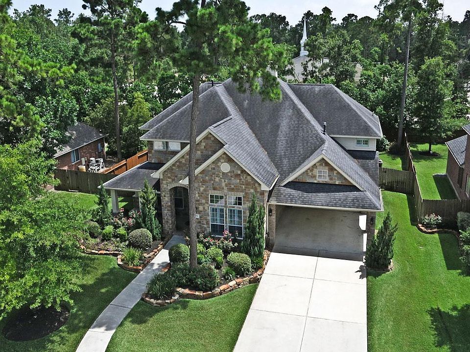 Stone Veneer Exterior with covered front patio, upgraded landscaping, mosquito systems and full spri